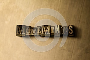 MOVEMENTS - close-up of grungy vintage typeset word on metal backdrop