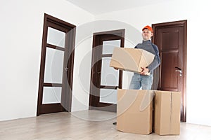 Mover with cardboard boxes in house