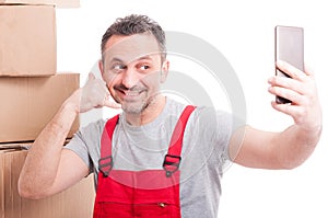 Mover guy making calling gesture taking selfie and smiling