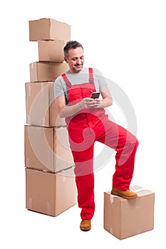 Mover guy standing in deposit texting on phone