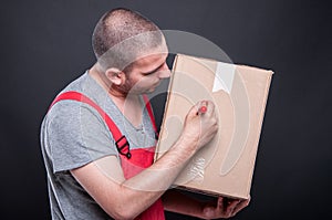 Mover guy writing on box with red marker