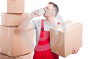 Mover man holding box and drinking coffee