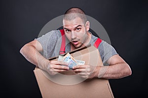 Mover man holding box showing euro bills