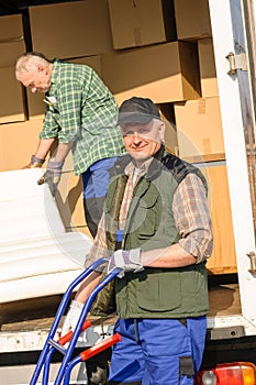 Mover two man loading furniture on truck