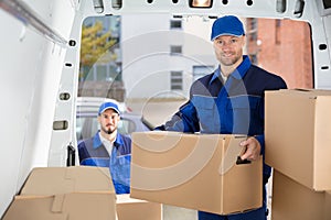 Mover Unloading Cardboard Box From Truck