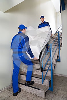 Movers Carrying Sofa On Steps