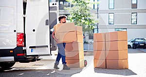 Movers With Delivery Boxes Near Van