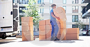 Movers With Delivery Boxes Near Van