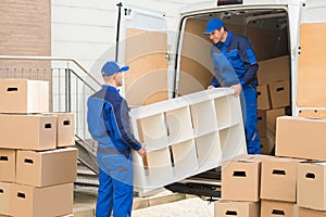 Movers Unloading Furniture From Truck