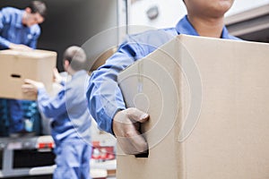 Movers unloading a moving van photo