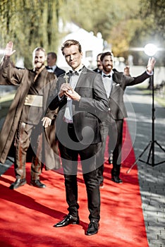 Movie actors on the red carpet outdoors