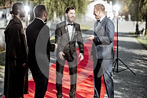 Movie actors on the red carpet outdoors