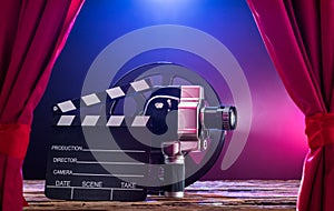 Movie Camera With Clapperboard And Film Reel On Stage