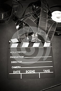 Movie clapper board and filmstrip selective focus