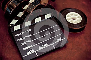 Movie clapper board and filmstrip selective focus