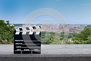 Movie clapper board on Rome scenic view