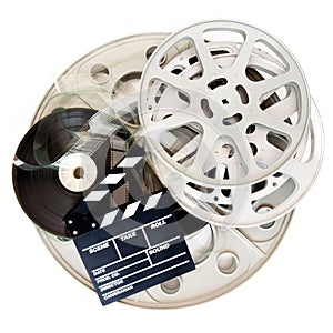 Movie clapper and different cinema film reel isolated on white