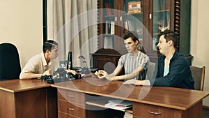 Movie director in white shirt angry reading screenplay with office laborers over