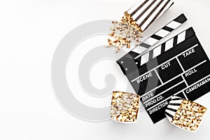 Movie film reel with clapperboard and popcorn. Cinema concept