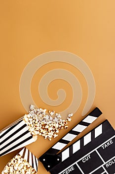 Movie film reel with clapperboard and popcorn. Cinema concept