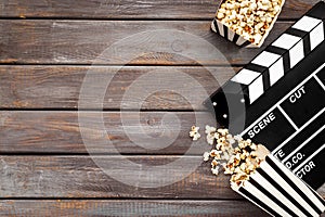 Movie film reel with clapperboard and popcorn. Cinema concept