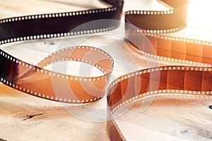 Movie film strips on wooden background