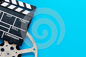 Movie premiere concept with clapperboard, film type on blue background top view space for text