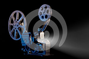 Movie projector with film reels on black background photo