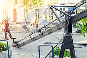 Movie set with professional equipment and media production team on city street. Outdoor film making. Big camera crane with