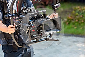 Movie shooting or video production and film crew team with camera equipment. Video camera operator working with equipment. Directo photo