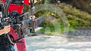 Movie shooting or video production and film crew team with camera equipment. Video camera operator working with equipment. Directo photo