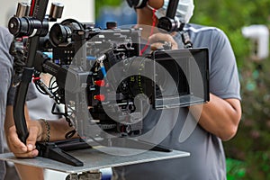 Movie shooting or video production and film crew team with camera equipment. Video camera operator working with equipment. Directo photo