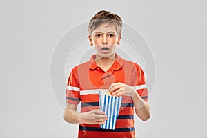 Boy eating popcorn photo