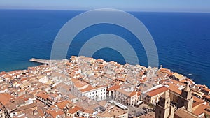 Moving aerial view from the mountains to the town of Cefalu in Sicily