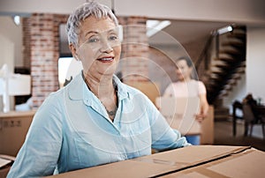 Moving on with a box full of memories. a senior woman moving house with help from her daughter.