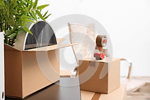 Moving box with office stuff on table indoors