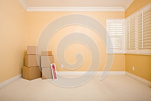 Moving Boxes and Foreclosure Sign in Empty Room