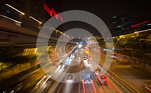 Moving cars with fast blurred trail of headlights