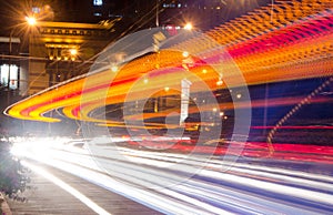 Moving cars with fast blurred trail of headlights