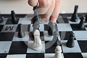 Moving a chess piece while playing a chess game at home