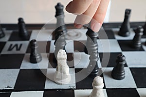 Moving a chess piece while playing a chess game at home