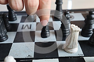Moving a chess piece while playing a chess game at home