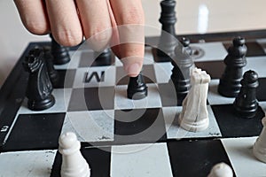 Moving a chess piece while playing a chess game at home