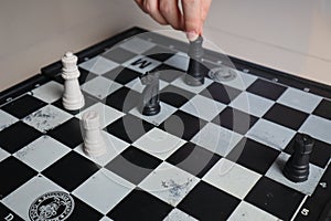 Moving a chess piece while playing a chess game at home