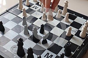 Moving a chess piece while playing a chess game at home