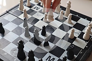 Moving a chess piece while playing a chess game at home