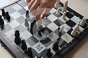 Moving a chess piece while playing a chess game at home