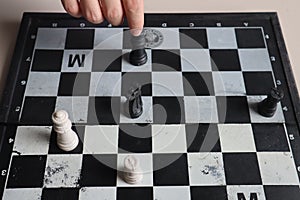 Moving a chess piece while playing a chess game at home