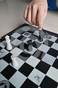 Moving a chess piece while playing a chess game at home