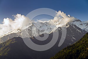 Moving clouds at high snow peak mountain plateau.